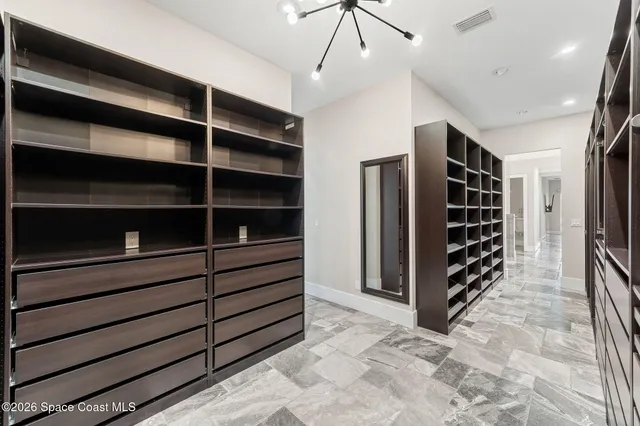 a view of a white house with a swimming pool and a yard