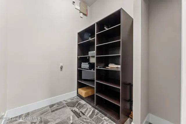 a view of a big house with a big yard and potted plants