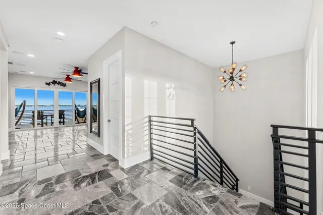 an aerial view of a house with a swimming pool patio and swimming pool