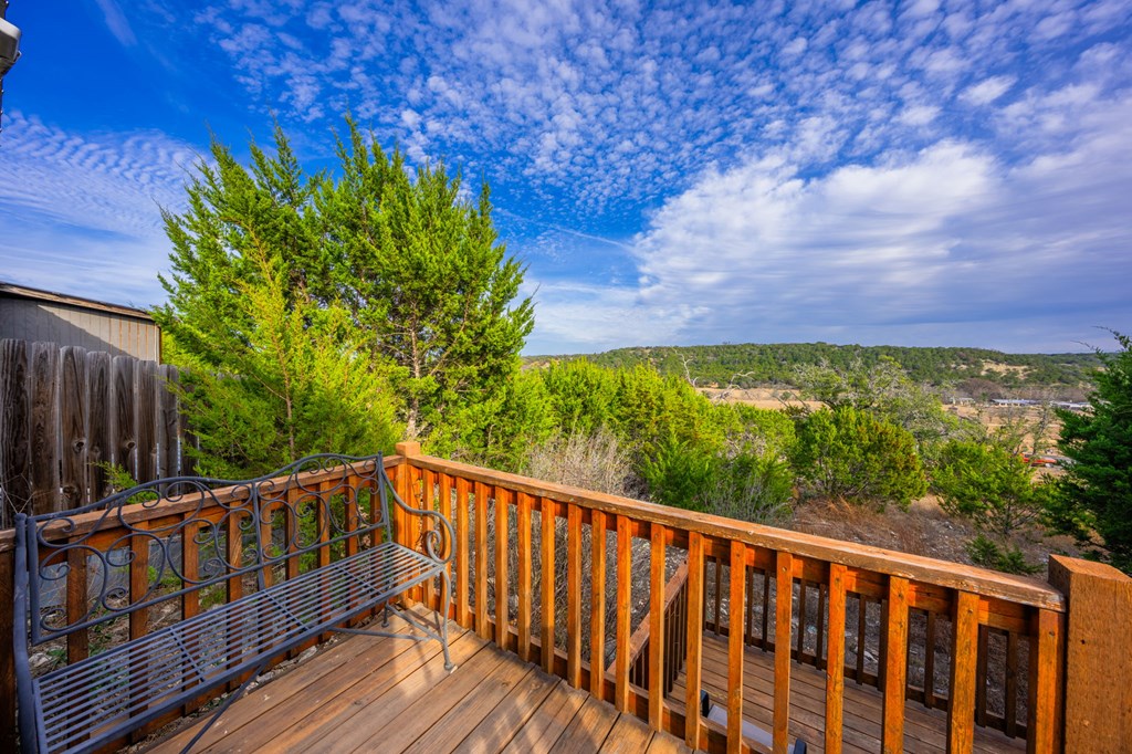 152 Henderson Branch Road West Ingram, TX 78025 - Photo 18 of 47 a balcony with wooden floor and yard in the back