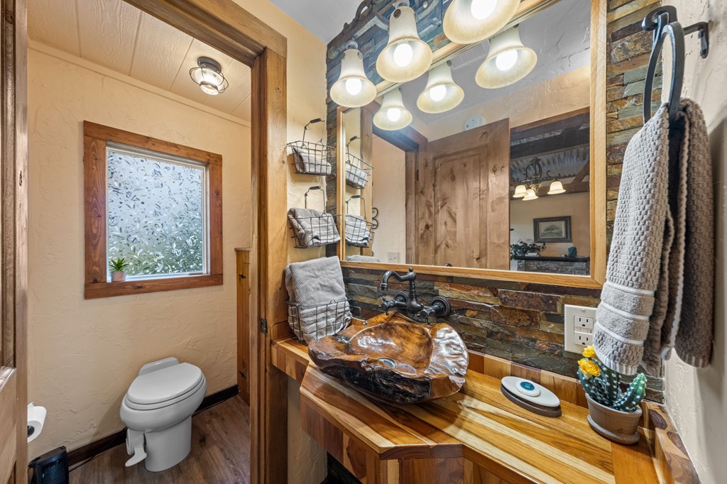 152 Henderson Branch Road West Ingram, TX 78025 - Photo 25 of 47 a bathroom with a granite countertop sink and a mirror