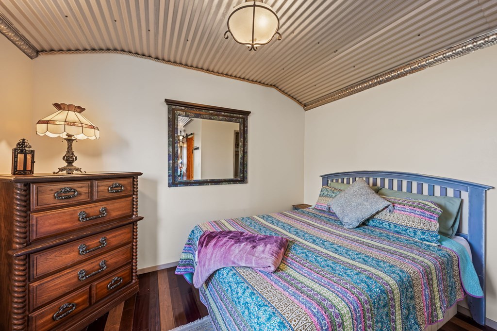 152 Henderson Branch Road West Ingram, TX 78025 - Photo 31 of 47 a bedroom with a bed and a dresser