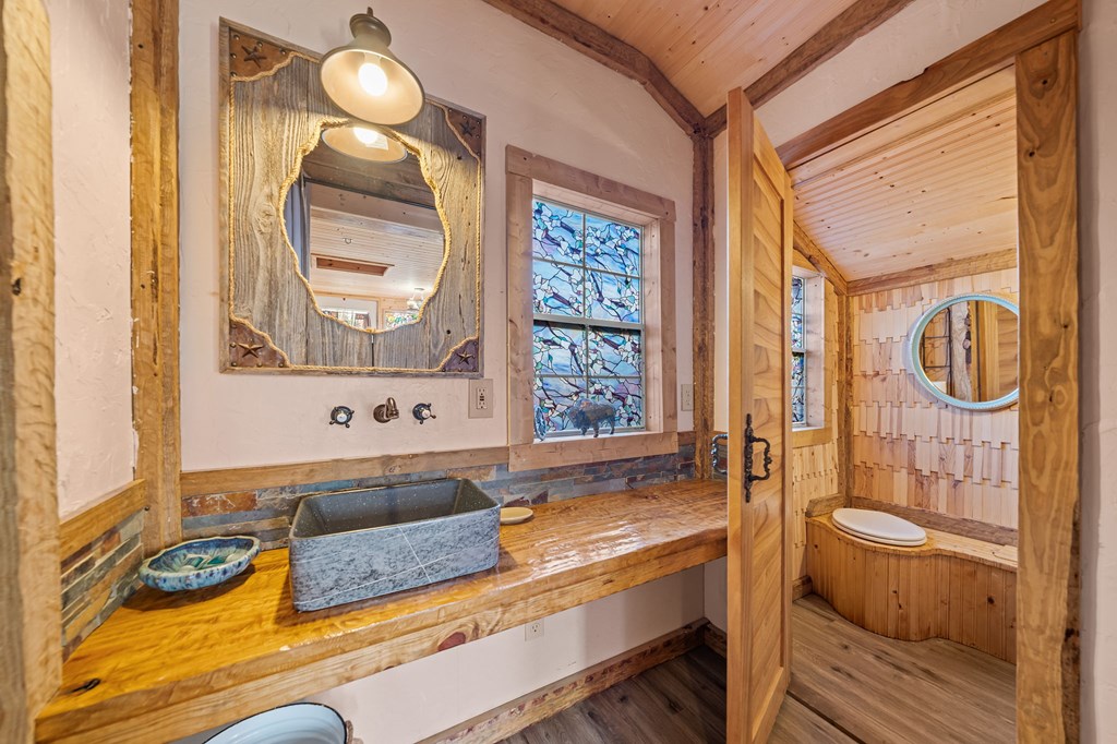 152 Henderson Branch Road West Ingram, TX 78025 - Photo 43 of 47 a bathroom with a granite countertop tub and a sink