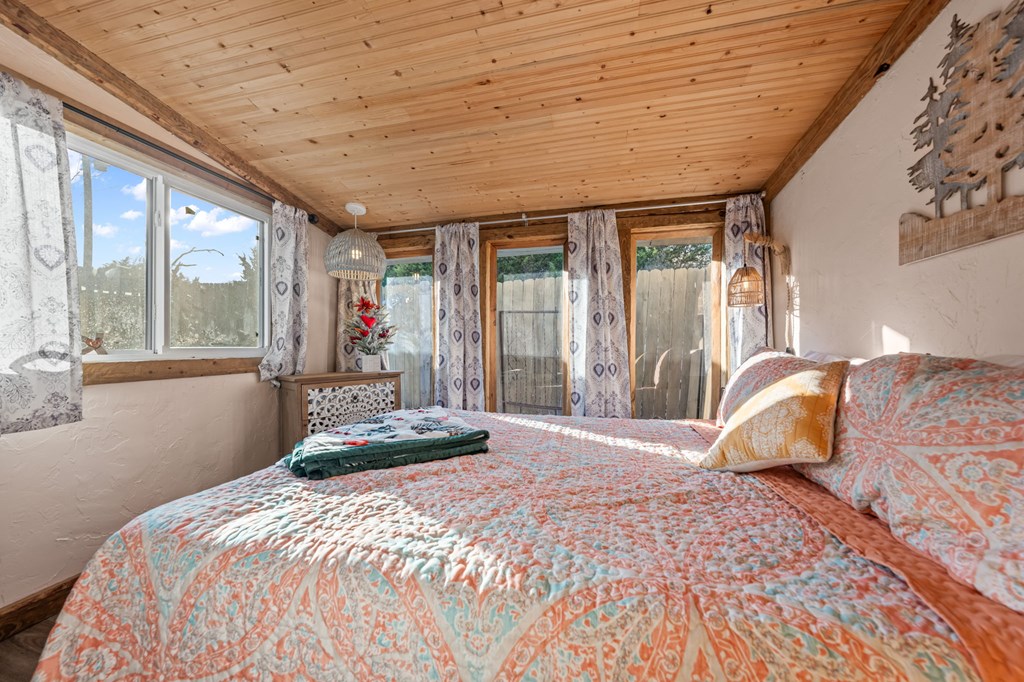 152 Henderson Branch Road West Ingram, TX 78025 - Photo 44 of 47 a bedroom with a large bed and large windows