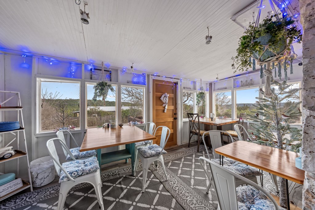 152 Henderson Branch Road West Ingram, TX 78025 - Photo 8 of 47 a dining room with furniture a rug and a potted plant