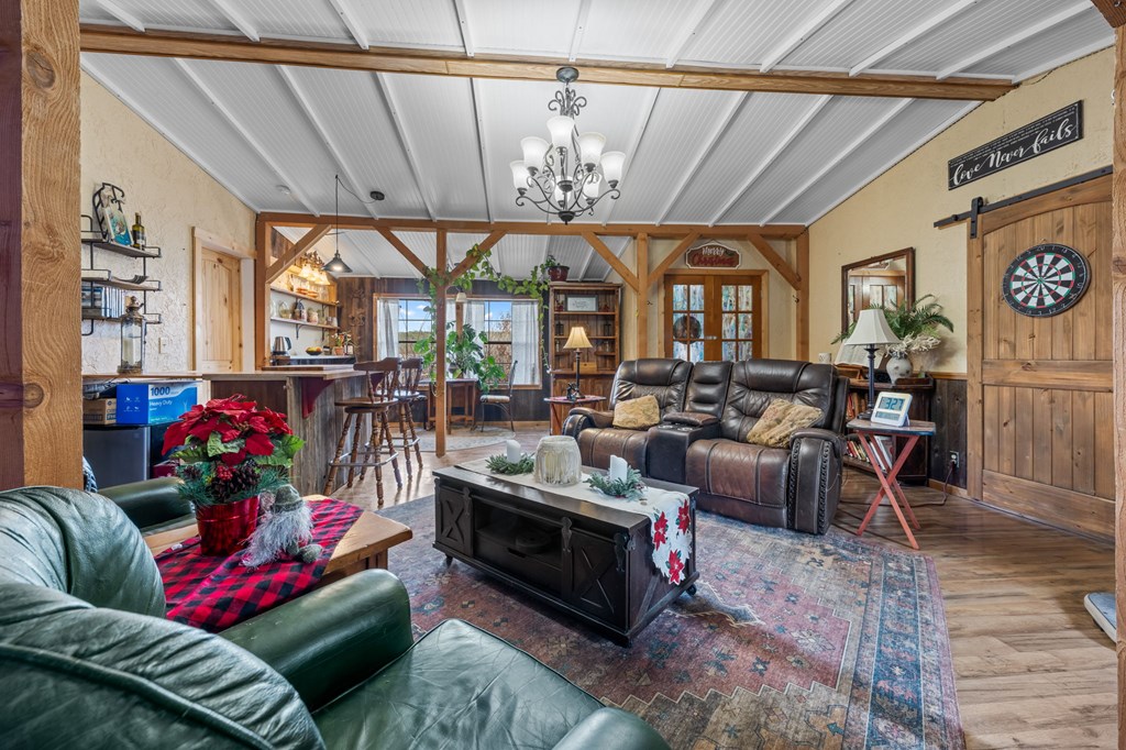 152 Henderson Branch Road West Ingram, TX 78025 - Photo 9 of 47 a living room with furniture a chandelier and a dining table