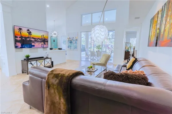 a living room with furniture and a chandelier