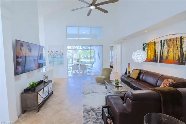 a large white kitchen with a large window