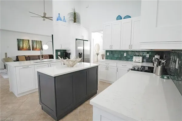 a kitchen with a stove a sink and a refrigerator