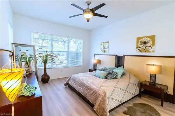a bedroom with furniture and a flat screen tv