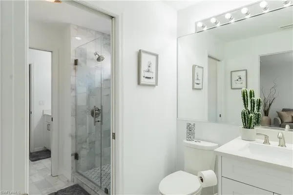 a bed sitting in a bedroom and a lamp