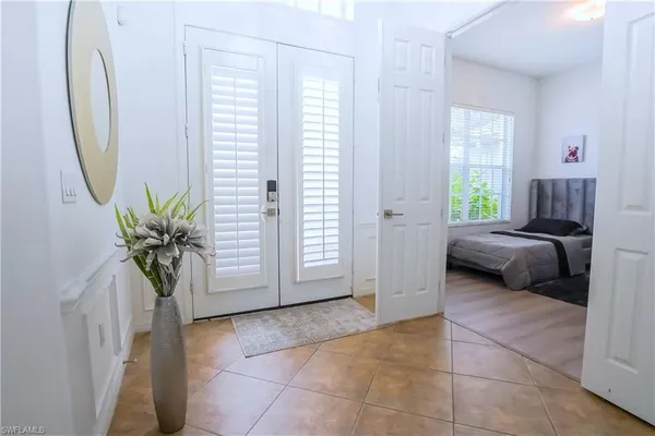 a bedroom with two beds and a large window