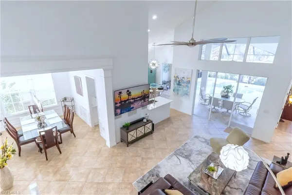 a view of a dining room with furniture and a potted plant