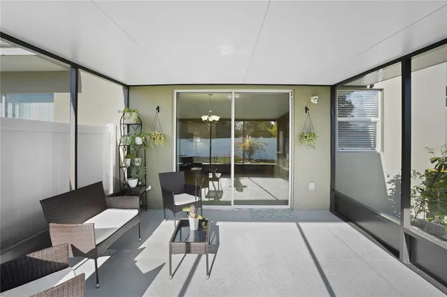 a living room with furniture and a glass door