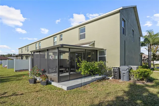 a view of a house with backyard and sitting area