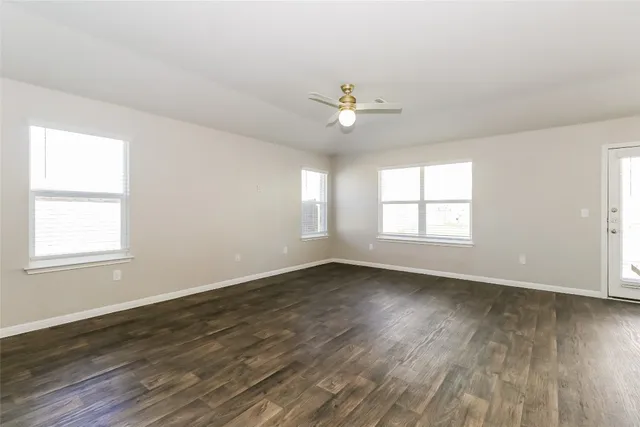 a view of kitchen with refrigerator stove and wooden floor