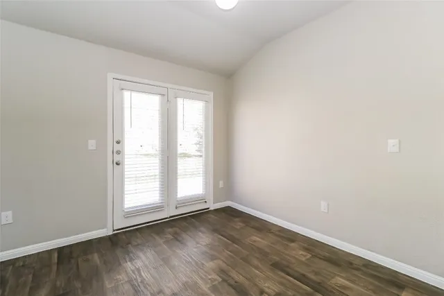 a dining room with furniture potted plants and wooden floor