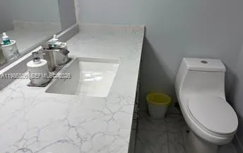 a bathroom with a toilet and a mirror