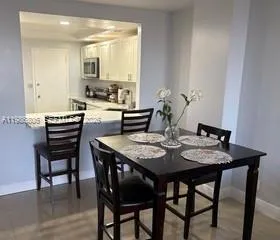 a dining room with furniture and wooden floor
