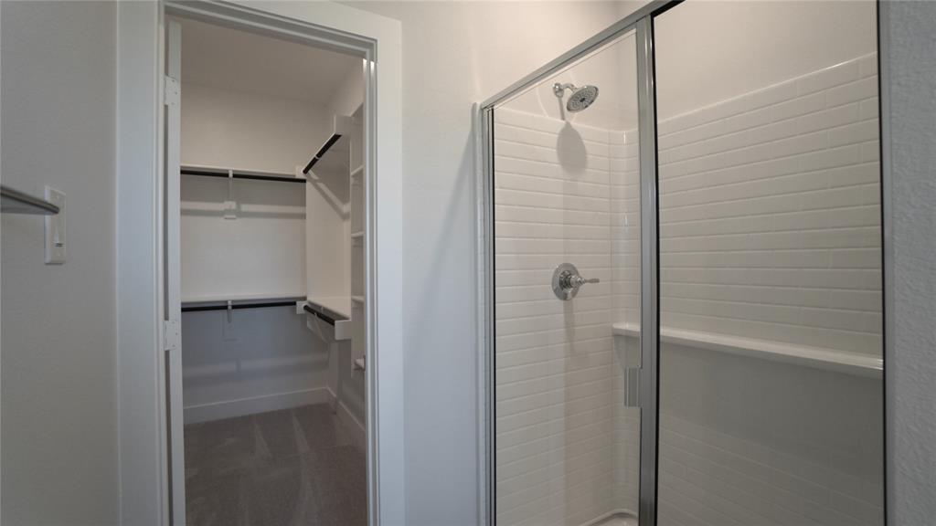 1374 Chisos Way Forney, TX 75126 - Photo 16 of 25 a bathroom with a glass shower door