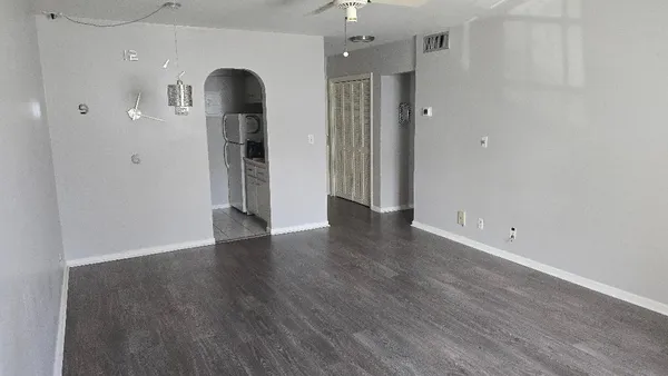 a view of a room with wooden floor and a white doors