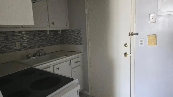 a kitchen with a sink and cabinets