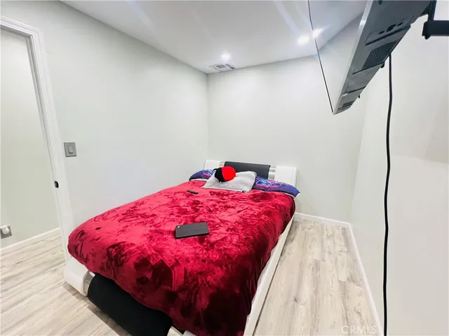 a bed sitting in a bedroom next to a window