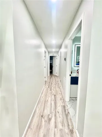 a view of a room with wooden floor