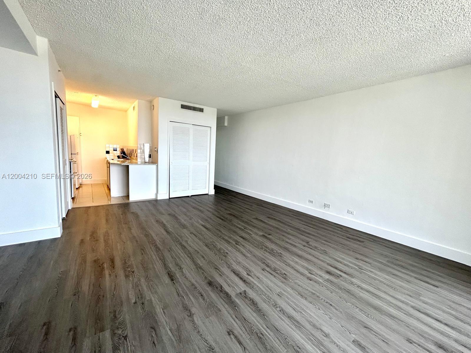 1500 Bay Road, Unit 1172S Miami Beach, FL 33139 - Photo 11 of 15 a view of empty room with wooden floor