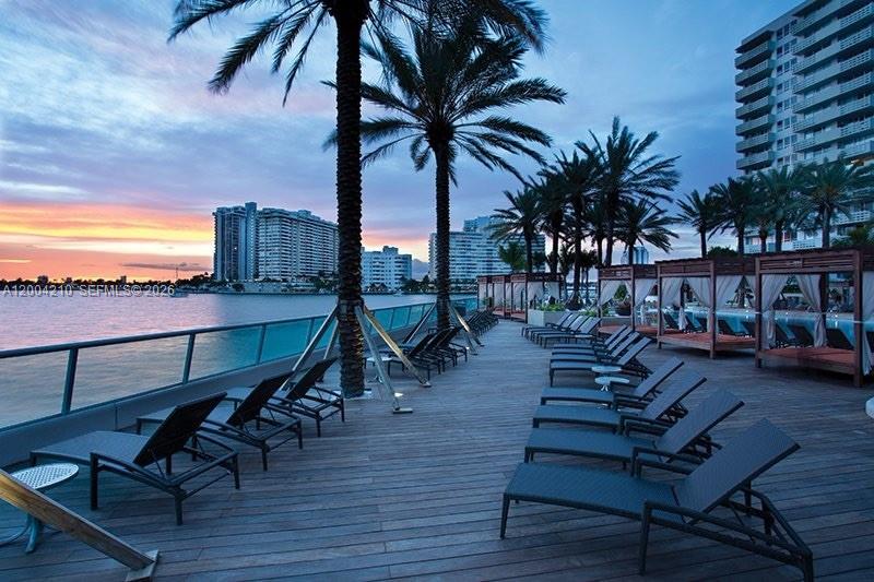 1500 Bay Road, Unit 1172S Miami Beach, FL 33139 - Photo 6 of 15 a view of a swimming pool with lounge chairs in patio