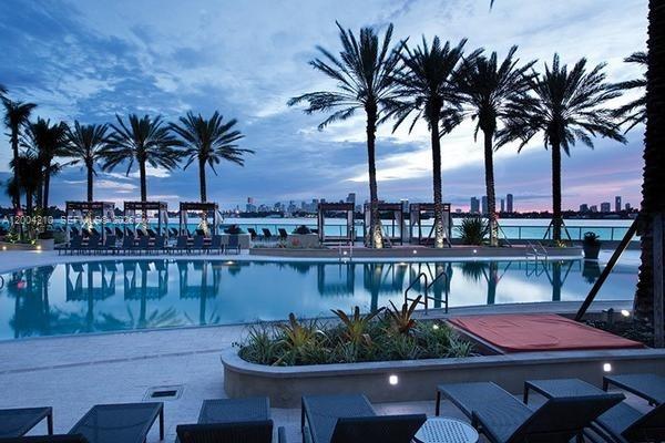 1500 Bay Road, Unit 1172S Miami Beach, FL 33139 - Photo 7 of 15 a view of a swimming pool with a table and chairs