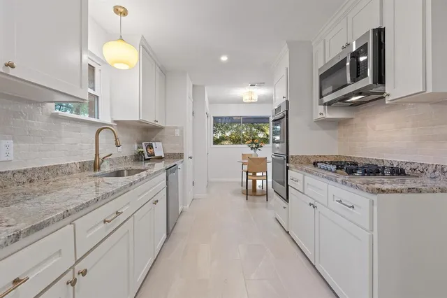 a bedroom with a bed chandelier and a window