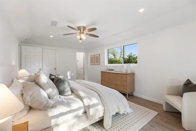 a view of a livingroom with a ceiling fan and window