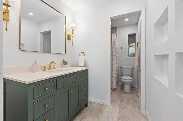 a view of a livingroom with furniture and a potted plant