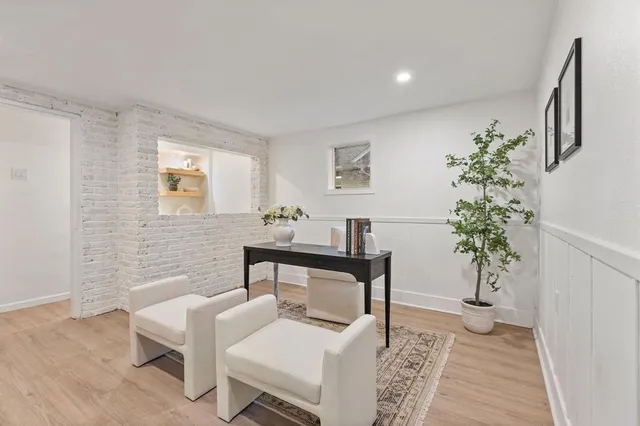 a living room with furniture and a potted plant