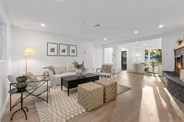 a view of a dining room with furniture and a chandelier