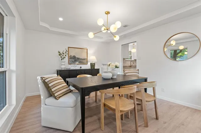 a kitchen with granite countertop a sink and white cabinets