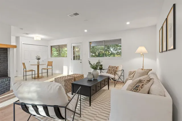 a kitchen with granite countertop a sink a stove cabinets and wooden floor