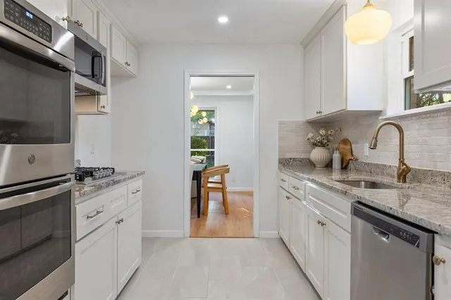 a spacious bedroom with a bed and a chandelier