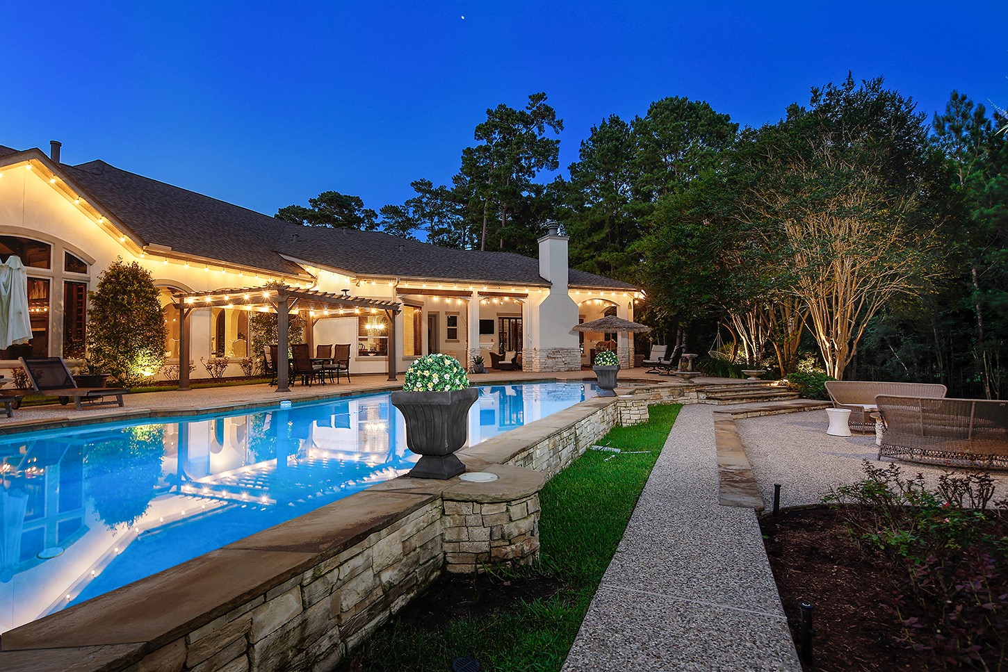 119 Angel Leaf Road The Woodlands, TX 77380 - Photo 43 of 50 a view of a patio with couches table and chairs with wooden fence and plants