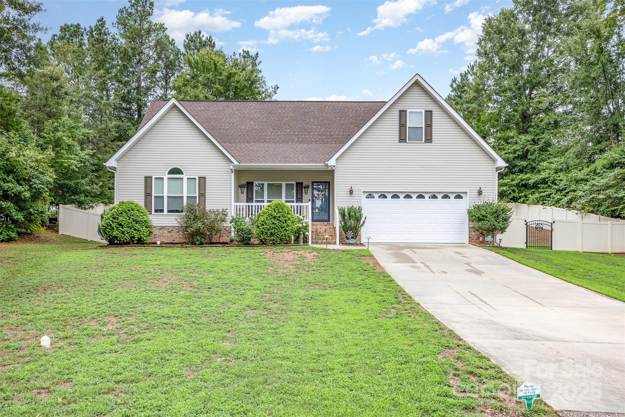 a view of backyard of house with green space