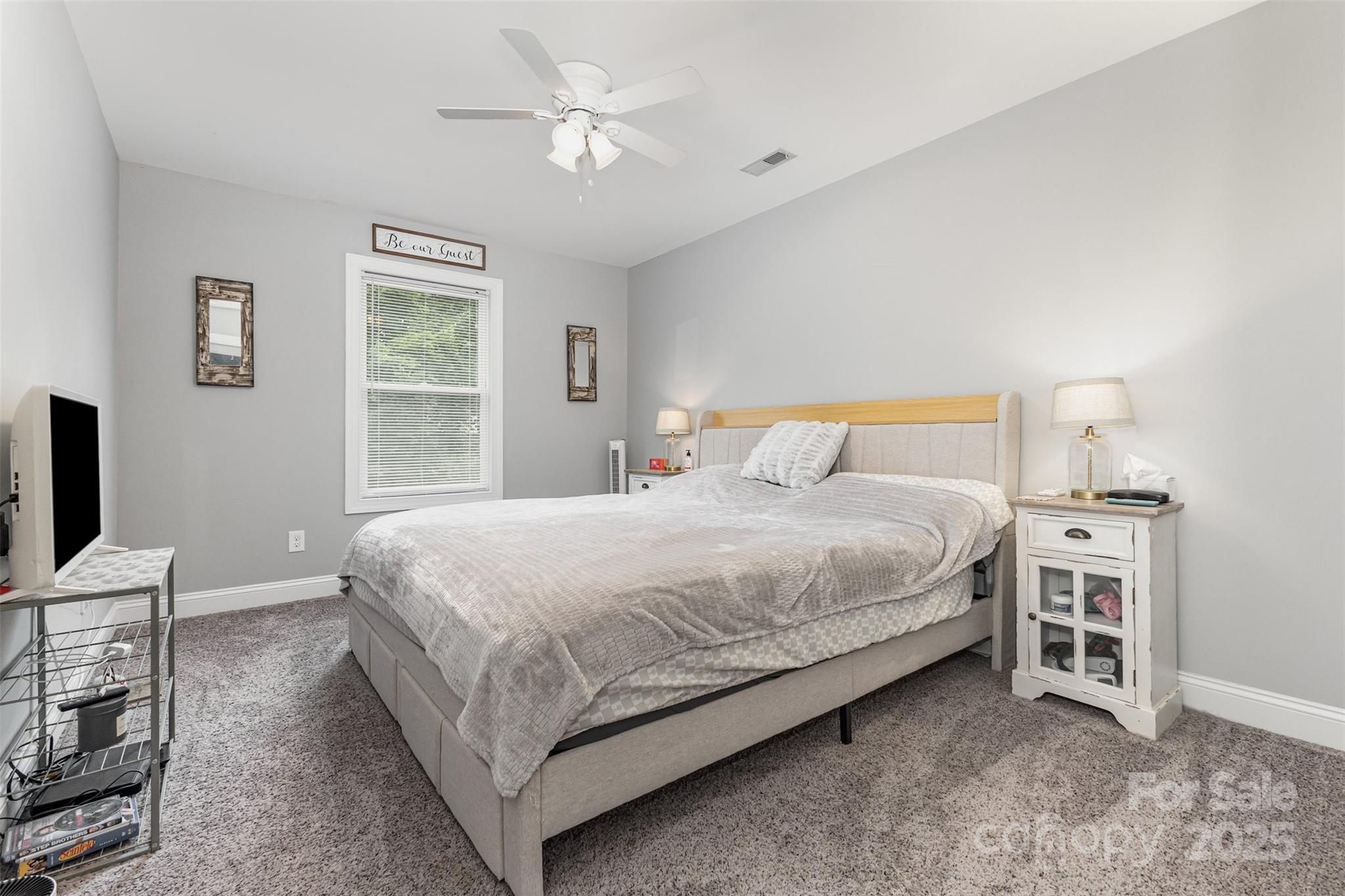 1785 Shamrock Avenue Lancaster, SC 29720 - Photo 20 of 30 a bedroom with a bed a chandelier and a flat tv screen on the dresser