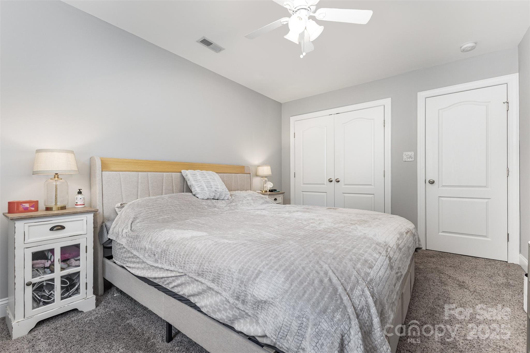 1785 Shamrock Avenue Lancaster, SC 29720 - Photo 21 of 30 a bedroom with a large bed and a chandelier