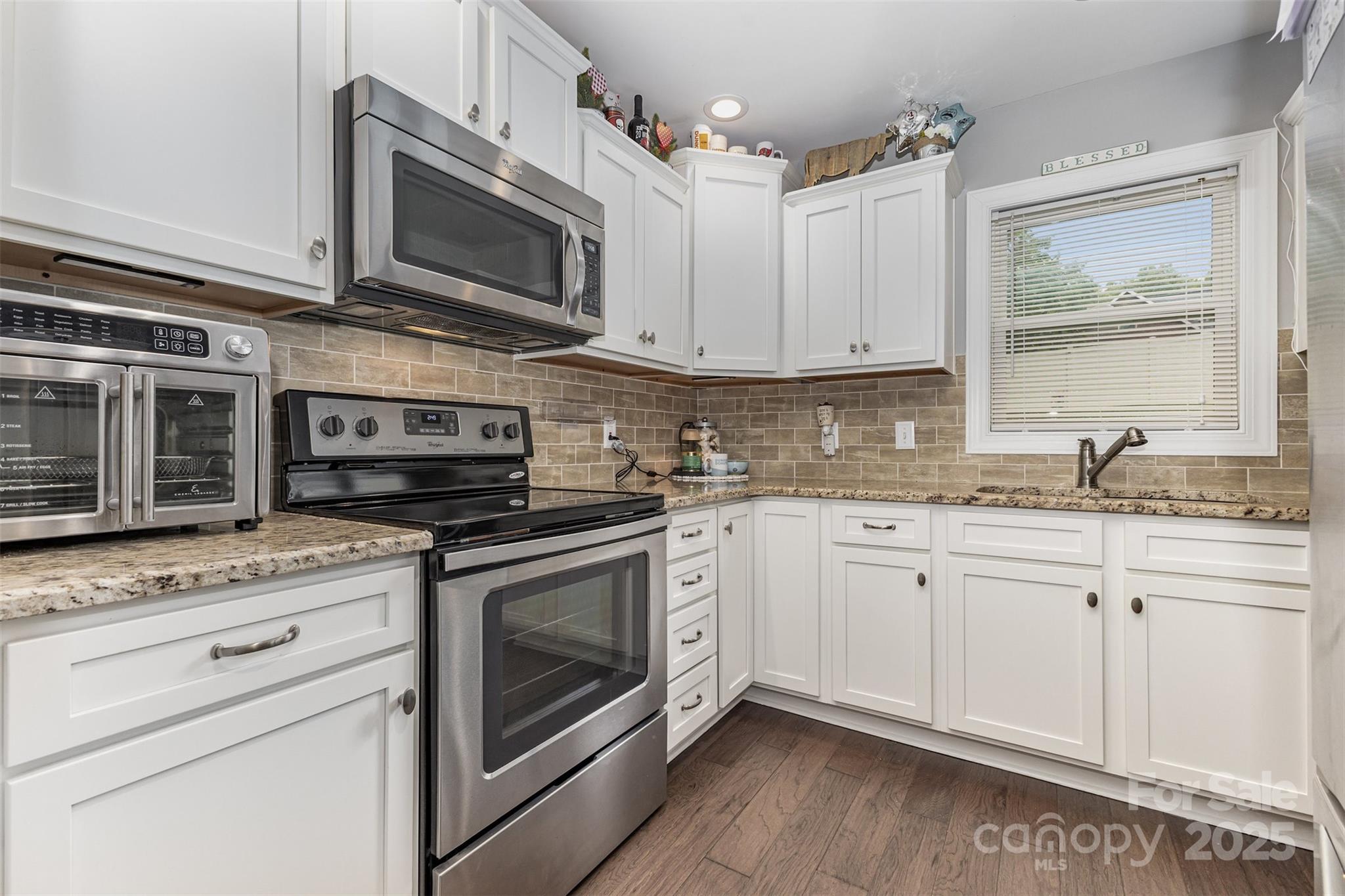 1785 Shamrock Avenue Lancaster, SC 29720 - Photo 7 of 30 a kitchen with stainless steel appliances granite countertop a stove microwave and cabinets