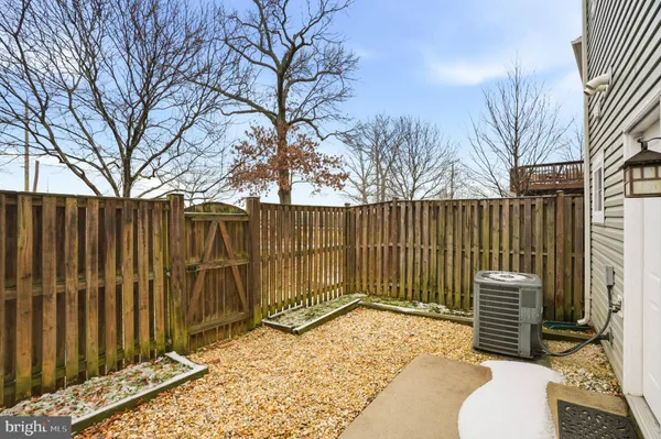 a view of a house with a door and wooden fence
