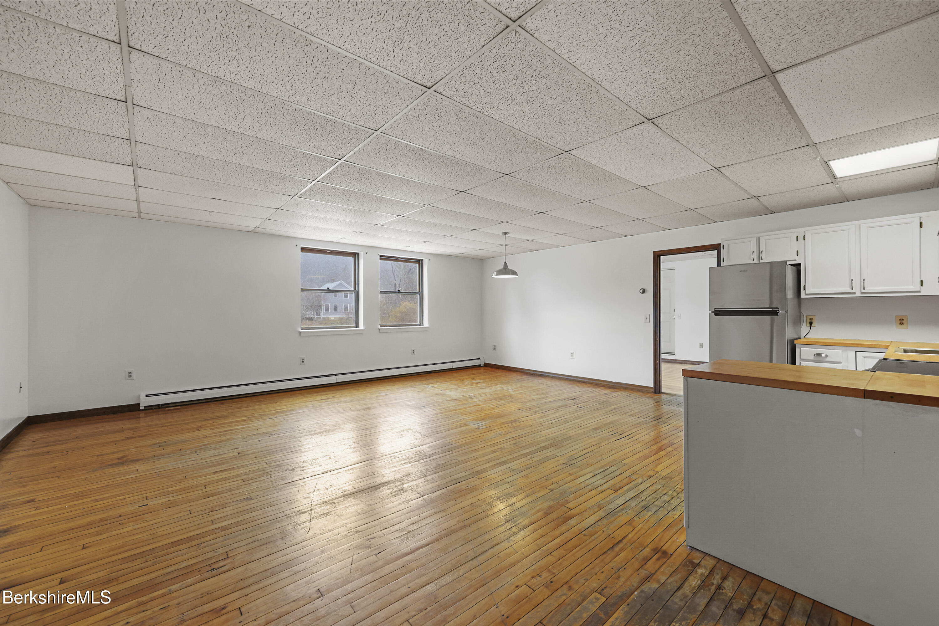55 Crystal Street, Unit 8 Lenox, MA 01242 - Photo 3 of 12 a view of a kitchen with wooden floor and a sink