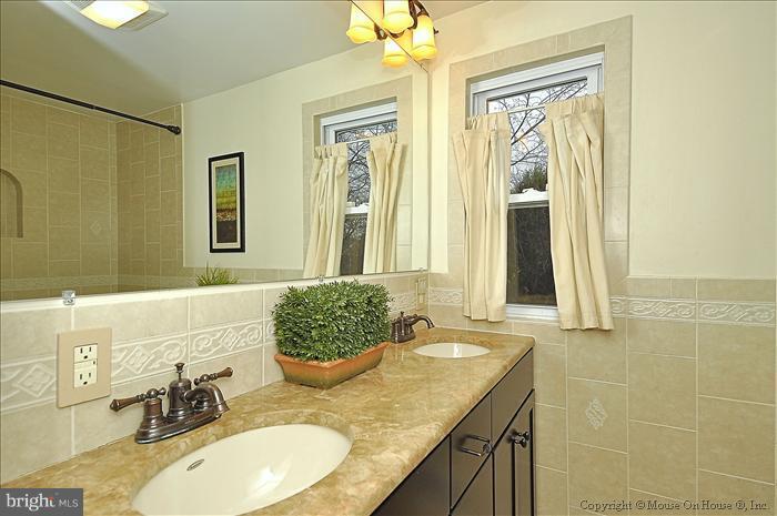 119 Indian Spring Drive Silver Spring, MD 20901 - Photo 7 of 11 a bathroom with a granite countertop sink and a mirror