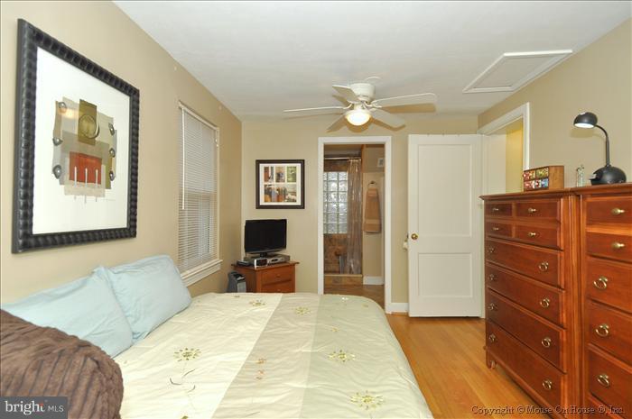 119 Indian Spring Drive Silver Spring, MD 20901 - Photo 10 of 11 a bedroom with a bed and a chandelier