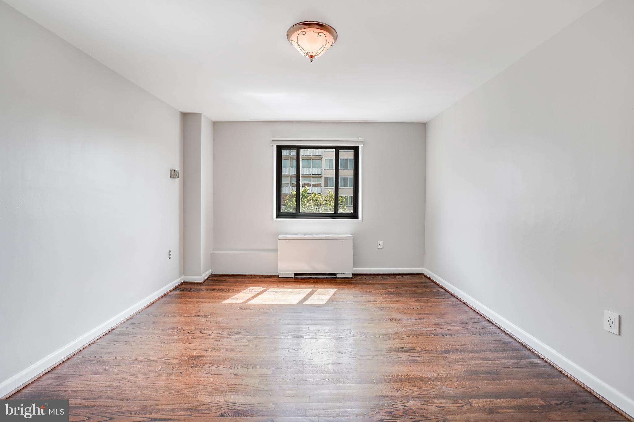 1200 South Arlington Ridge Road, Unit 618 Arlington, VA 22202 - Photo 10 of 17 an empty room with wooden floor and windows