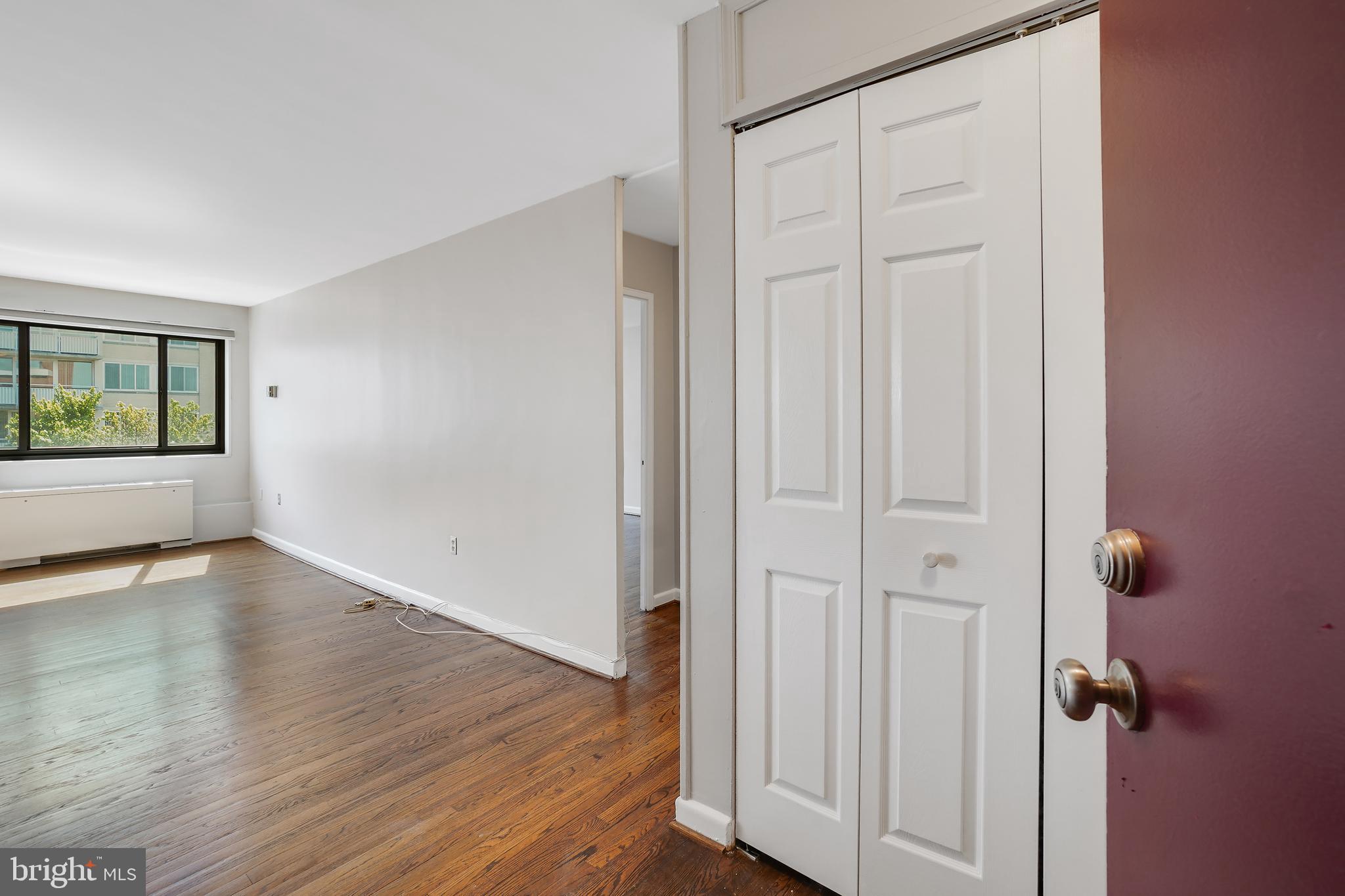 1200 South Arlington Ridge Road, Unit 618 Arlington, VA 22202 - Photo 2 of 17 an empty room with wooden floor and windows